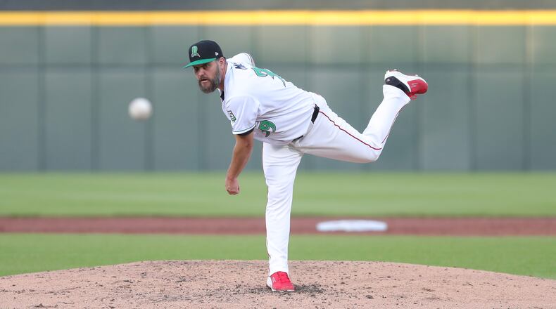 Cincinnati Reds pitcher Wade Miley delivers a pitch for the Dayton Dragons during their game against the West Michigan Whitecaps on Tuesday night at Day Air Ballpark. Miley is with the team on a rehab assignment. Michael Cooper/STAFF