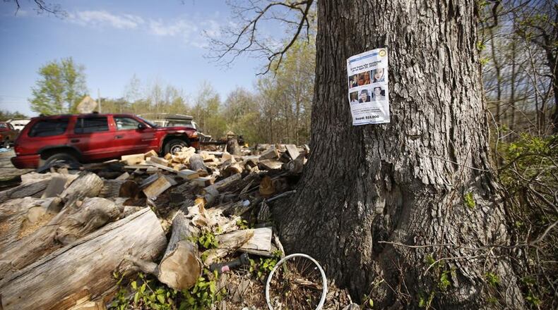 A reward poster for information about the Rhoden murders hangs in a tree outside the home of Leonard Manley, whose daughter Dana Rhoden, 37, was one of the eight victims in Pike County on April 22, 2016. The case remains unsolved. TY GREENLEES / STAFF