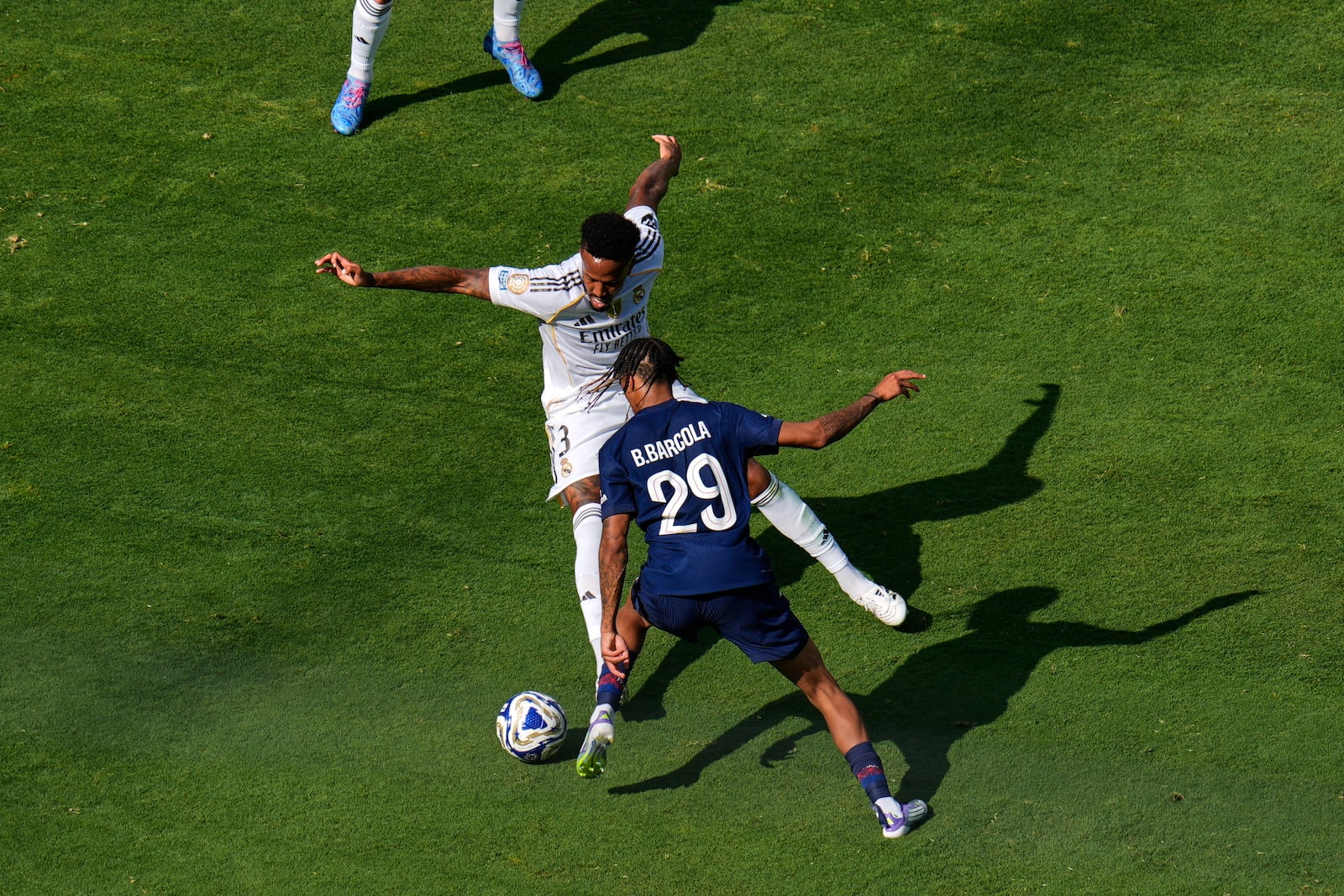 Paris Saint-Germain's Bradley Barcola (29) makes a pass to the front of the net past Real Madrid's Andriy Lunin (13) during the Club World Cup semifinal soccer match between PSG and Real Madrid in East Rutherford, N.J., Wednesday, July 9, 2025. (AP Photo/Pamela Smith)