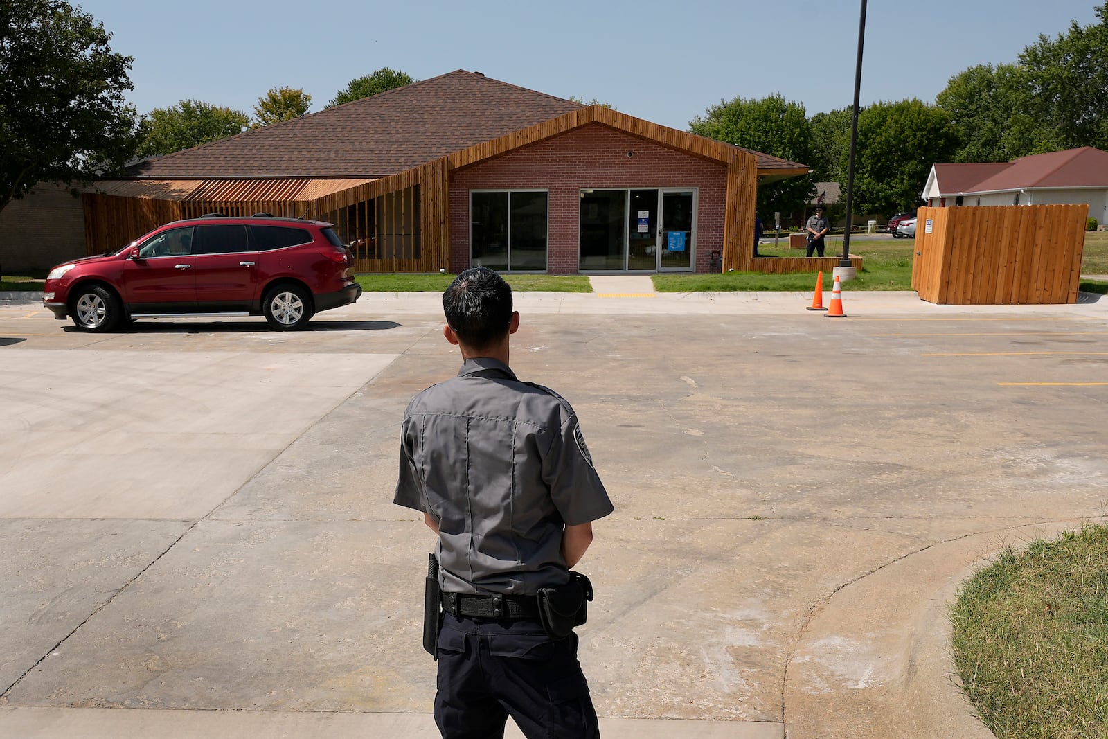 FILE - Security personnel stand outside a recently opened Planned Parenthood clinic, Sept. 10, 2024, in Pittsburg, Kan. (AP Photo/Charlie Riedel)