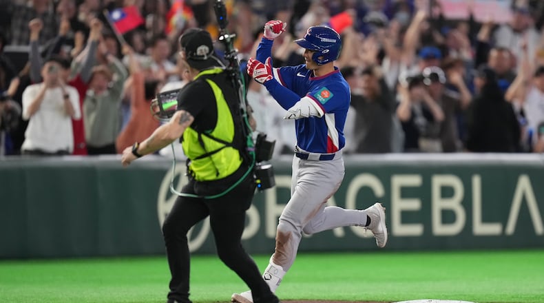 Taiwan's Stuart Fairchild runs past the third base as he calebrates his grand slam home run in the second inning of a World Baseball Classic game between Taiwan and Czechia in Tokyo, Saturday, March 7, 2026. (AP Photo/Hiro Komae)
