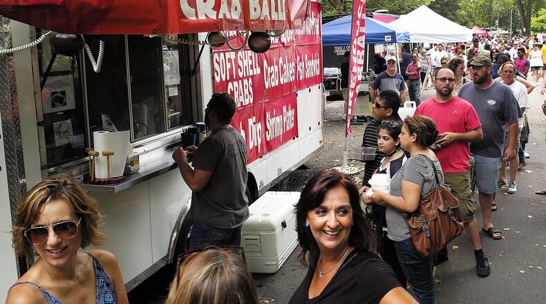 People wait in line to sample some of the Firehouse Crab Balls at the 2016 Springfield Rotary Gourmet Food Truck Competition in Veterans Park. Bill Lackey/Staff