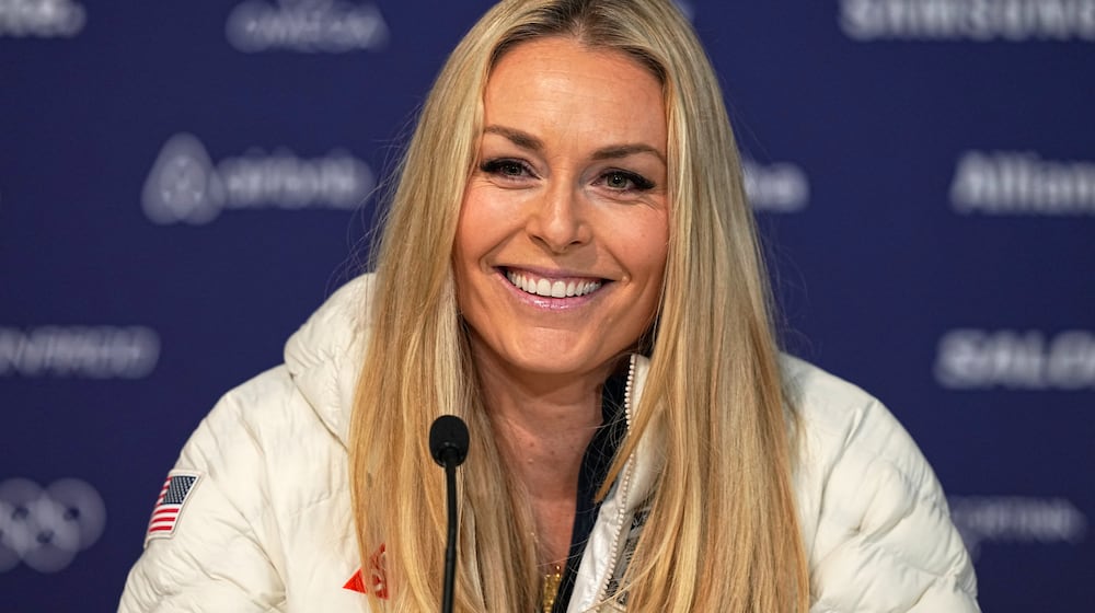 United States' Lindsey Vonn smiles during a press conference by the U.S. ski team at the 2026 Winter Olympics, in Cortina d'Ampezzo, Italy, Tuesday, Feb. 3, 2026. (AP Photo/Fatima Shbair)