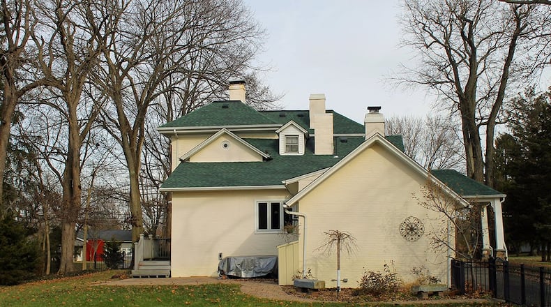 This property boasts a partially fenced yard and an abundance of mature trees, including fruit and nut trees. Other exterior features include a carport, a three-car garage, a covered porch and a rear patio.
