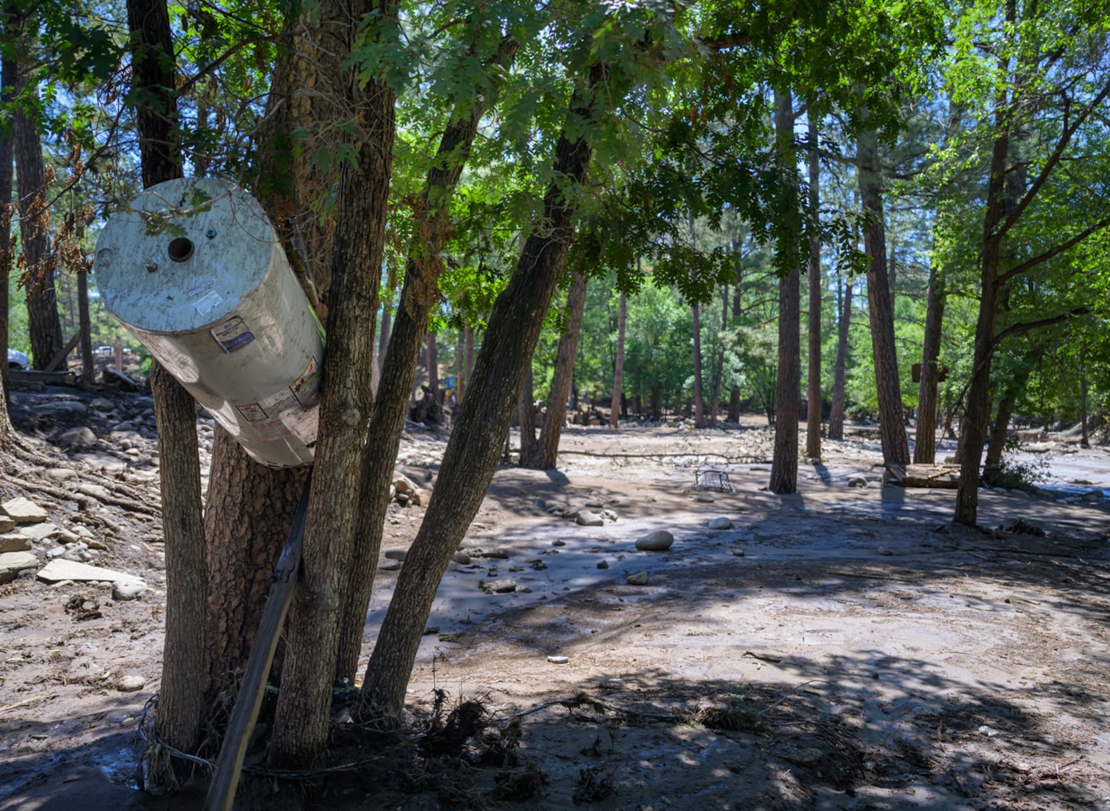A water heater got wedged between trees near the downtown area in the town of Ruidoso, N.M., Wednesday, July 9, 2025, during major flash flooding yesterday. (AP Photo/Roberto E. Rosales)