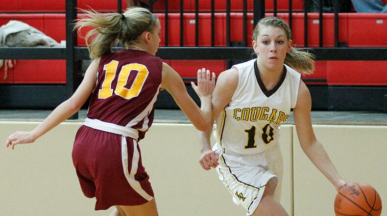 Sydney Bates (10) of Kenton Ridge is guarded by Madison Massie (10) of Northeastern during Thursday's Division II sectional basketball game at Tecumseh High School on Feb. 14, 2013. Barbara J. Perenic/Staff