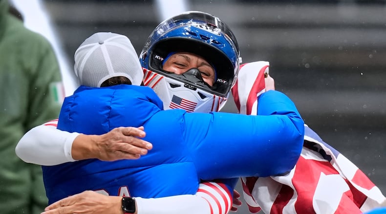 United States' gold medalist Elana Meyers Taylor celebrates at the finish after the women's monobob competition at the 2026 Winter Olympics, in Cortina d'Ampezzo, Italy, Monday, Feb. 16, 2026.(AP Photo/Aijaz Rahi)