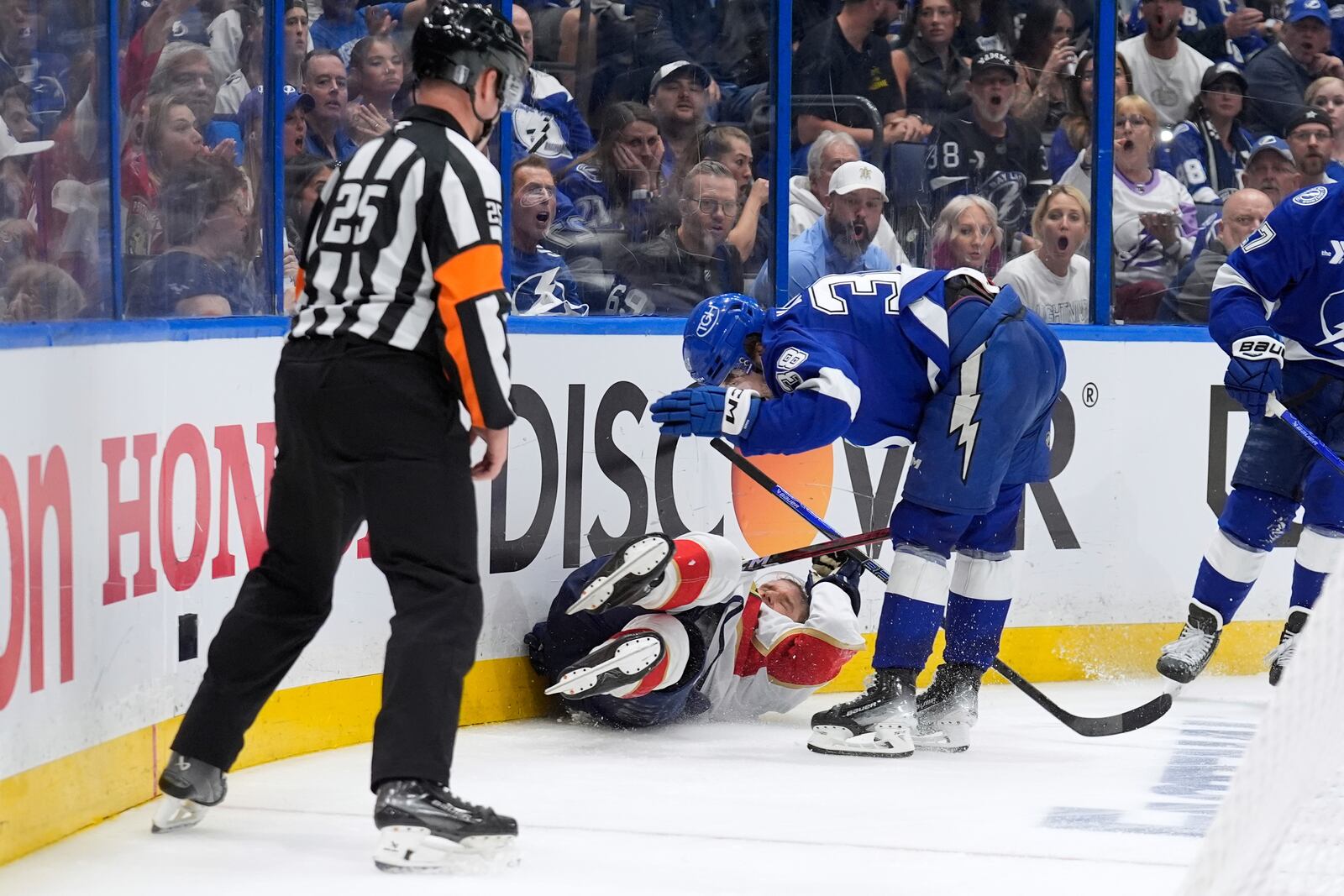 Tampa Bay Lightning left wing Brandon Hagel (38) takes down Florida Panthers center Aleksander Barkov (16) during the third period in Game 2 of an NHL hockey Stanley Cup first-round playoff series, Thursday, April 24, 2025, in Tampa, Fla. (AP Photo/Chris O'Meara)