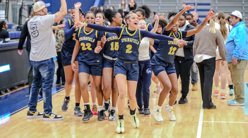 Springfield High School junior Milly Portis and her teammates celebrate after beating Centerville 47-46 on Tuesday night at Fairborn High School to advance to a district final game for the first time since the North-South merger in 2008. MICHAEL COOPER/CONTRIBUTED