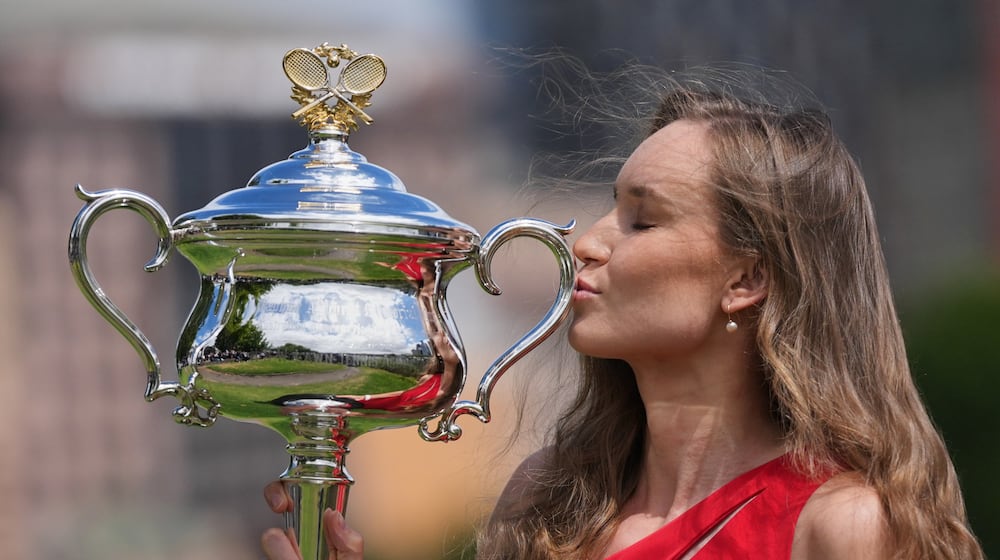 Elena Rybakina of Kazakhstan poses with Daphne Akhurst Memorial Cup on the banks of the Yarra River the morning after defeating Aryna Sabalenka of Belarus in the women's singles final at the Australian Open tennis championship in Melbourne, Australia, Sunday, Feb. 1, 2026. (AP Photo/Dita Alangkara)