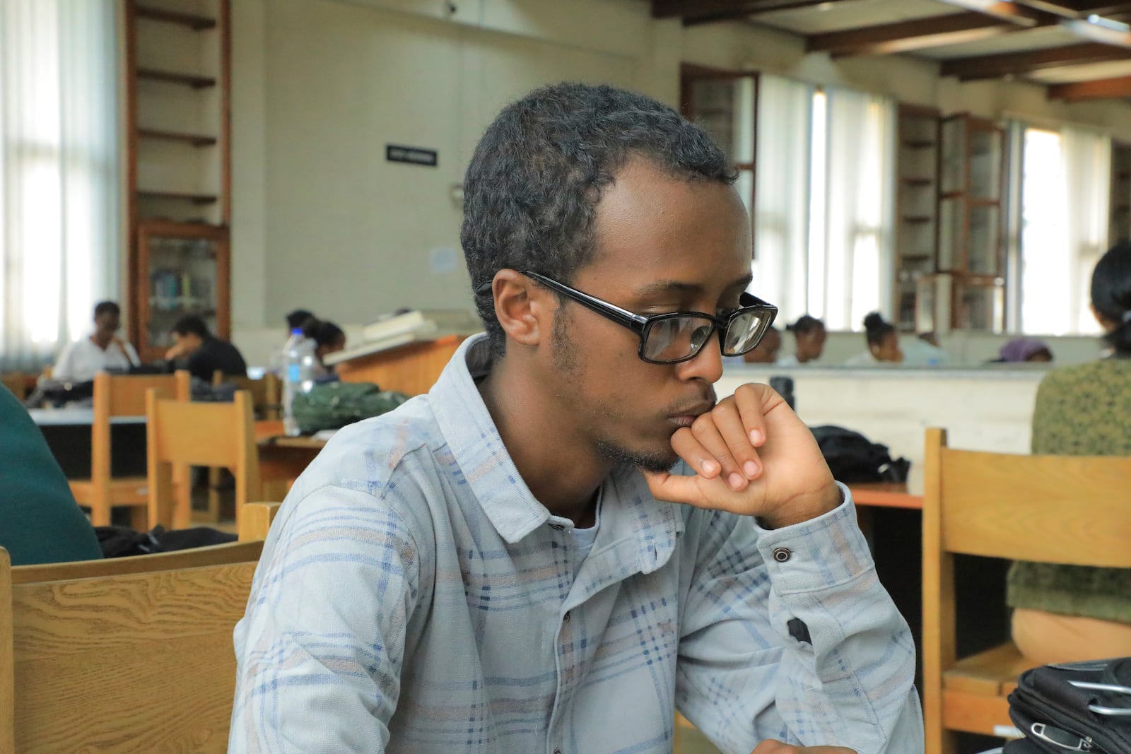 Yonas Nuguse, 21 years old, reads a book at Wemezeker National Library in Addis Ababa, Ethiopia Friday, May 30, 2025. (AP Photo/Amanuel Birhane)