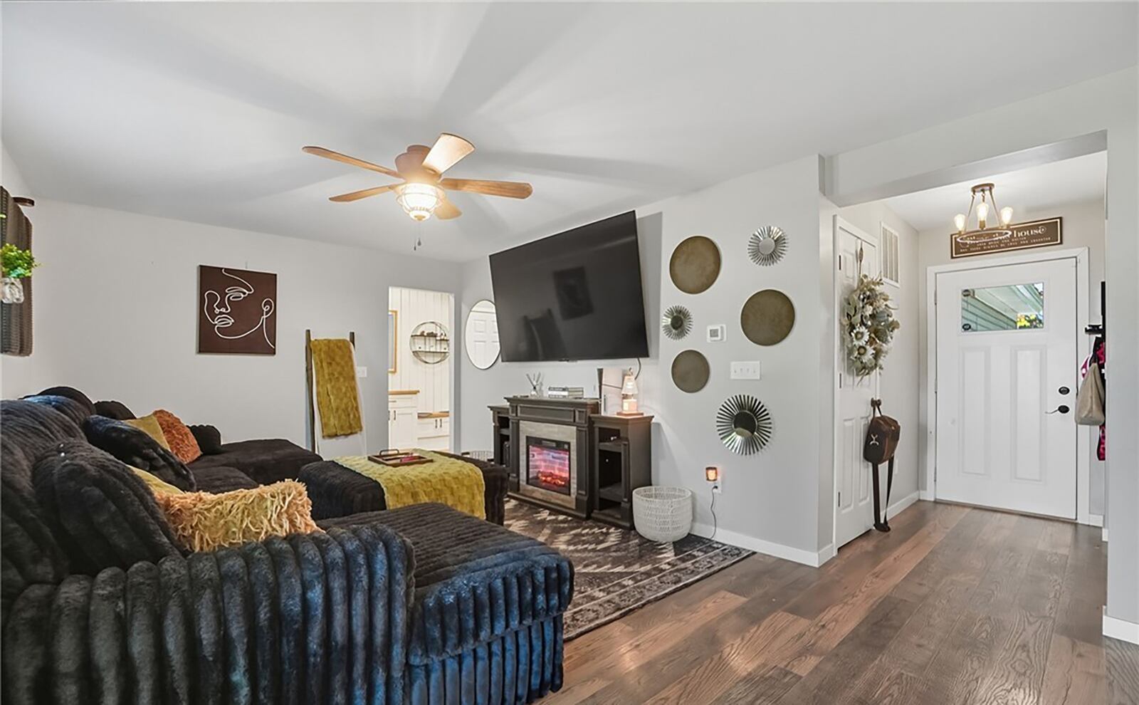 The living room has LVP flooring and a ceiling fan and is open to the kitchen and dining room. CONTRIBUTED