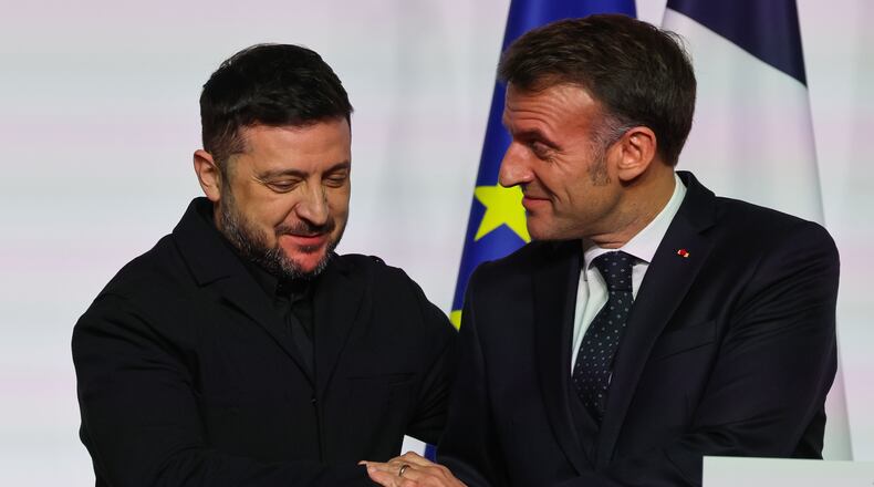 French President Emmanuel Macron, right, shakes hands to Ukraine's President Volodymyr Zelenskyy after the signing of the declaration on deploying post-ceasefire force in Ukraine during the 'Coalition of the Willing' summit on security guarantees for Ukraine, at the Elysee Palace in Paris Tuesday, Jan 6, 2026. (Ludovic Marin, Pool photo via AP)
