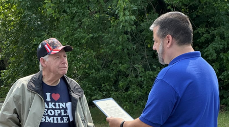 Cherish Hospice Administrator Jason R. Casto presents a challenge coin certificate to veteran Morris Lavender. CONTRIBUTED
