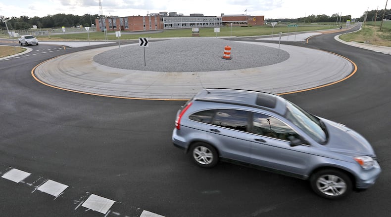 Clark County traffic navigates the new roundabout at the intersection of Selma and Possum Roads in front of Shawnee Schools Tuesday, August 30, 2022. BILL LACKEY/STAFF