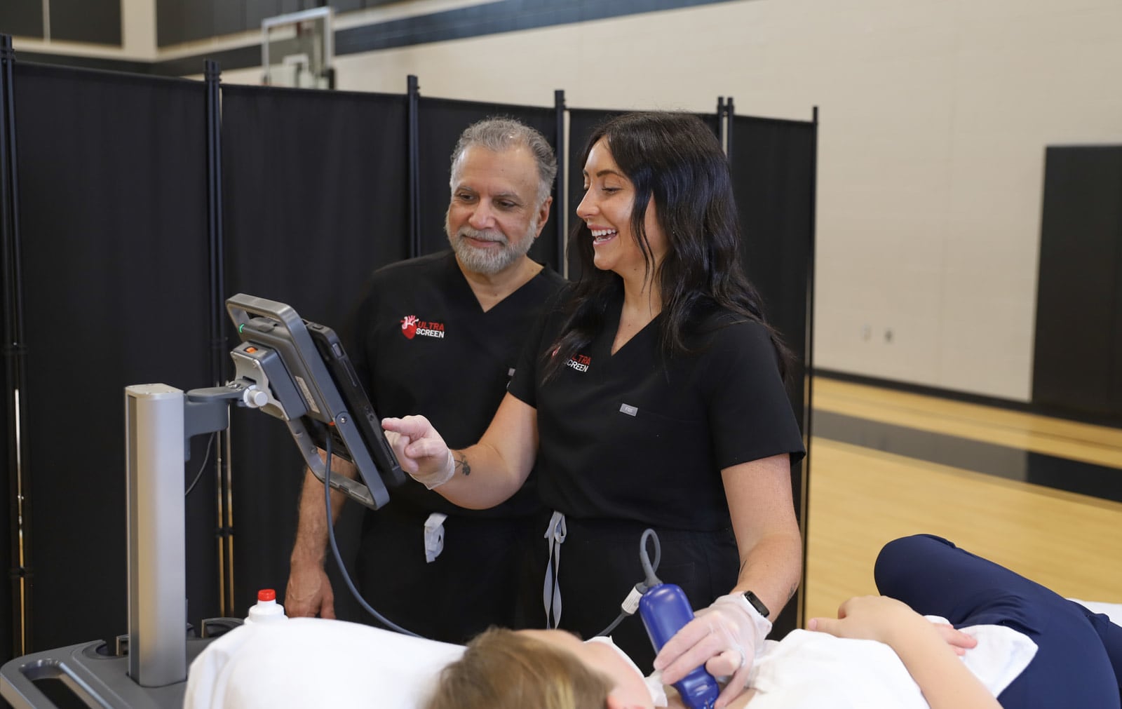 Board-certified cardiologist Dr. Faiq Akhter works with registered cardiac sonographer Emma Beedy on screening a patient for cardiac conditions as part of the services of their new mobile cardiac screening business, Ultrascreen. ELIZABETH NEWMAN PHOTOGRAPHY/CONTRIBUTED