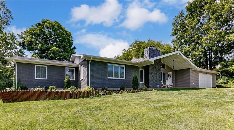 The front of the vinyl-and-brick ranch home has a covered front porch and two-car attached oversized garage with opener. Contributed photos