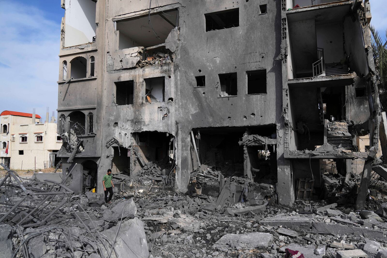 A Palestinian man walks on the rubble of the Al-Zainati family's home, destroyed by Israeli airstrikes in Khan Younis, Gaza Strip, on Thursday, May 15, 2025. (AP Photo/Abdel Kareem Hana)
