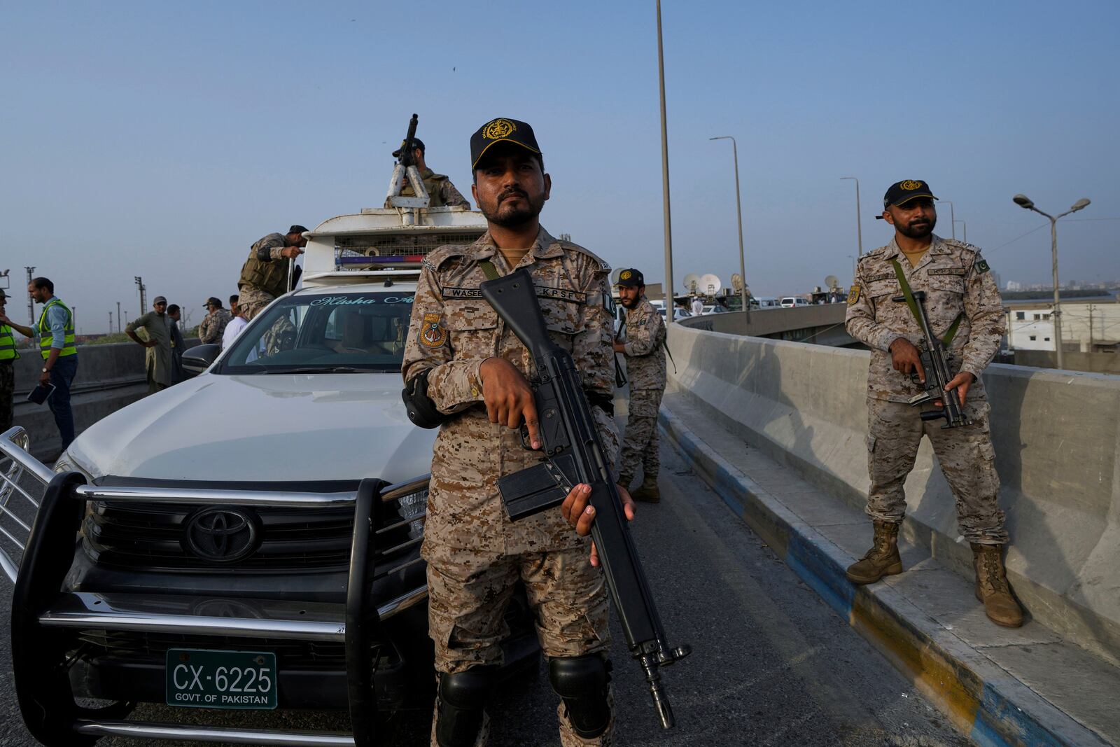 A paramilitary soldier stand alert on a road near Karachi port following raising military tension between Pakistan and India, in Karachi, Pakistan, Friday, May 9, 2025. (AP Photo/Fareed Khan)