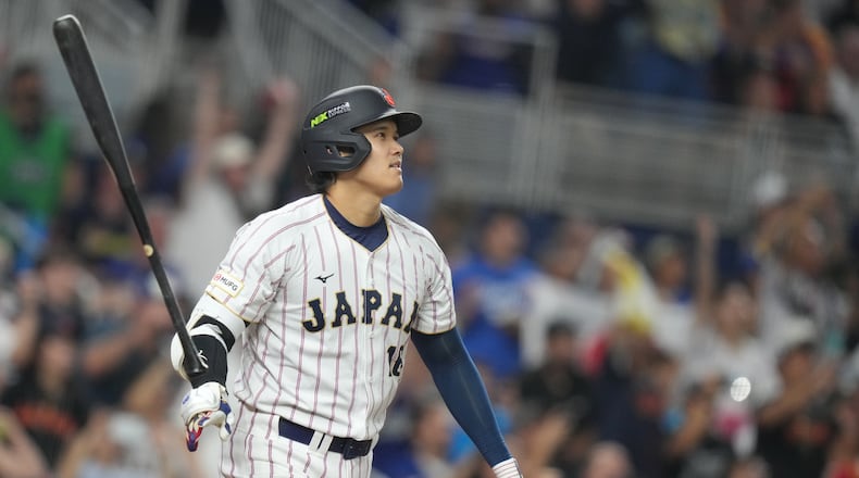 Japan's Shohei Ohtani hits a single home run during the first inning against Venezuela of a World Baseball Classic quarterfinal game, Saturday, March 14, 2026, in Miami. (AP Photo/Lynne Sladky)