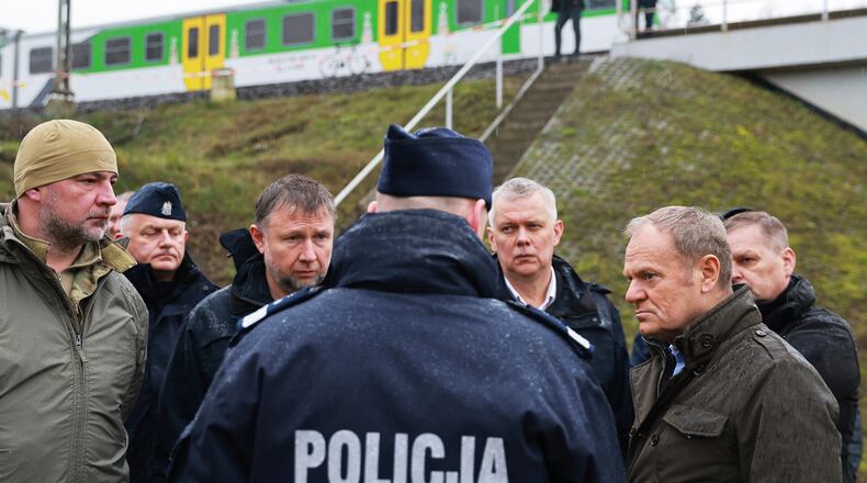 Prime Minister Donald Tusk, second right, visits site of the rail line Mika, that was damaged by sabotage, near Deblin, Poland, Monday, Nov. 17, 2025. (AP Photo/KPRM)