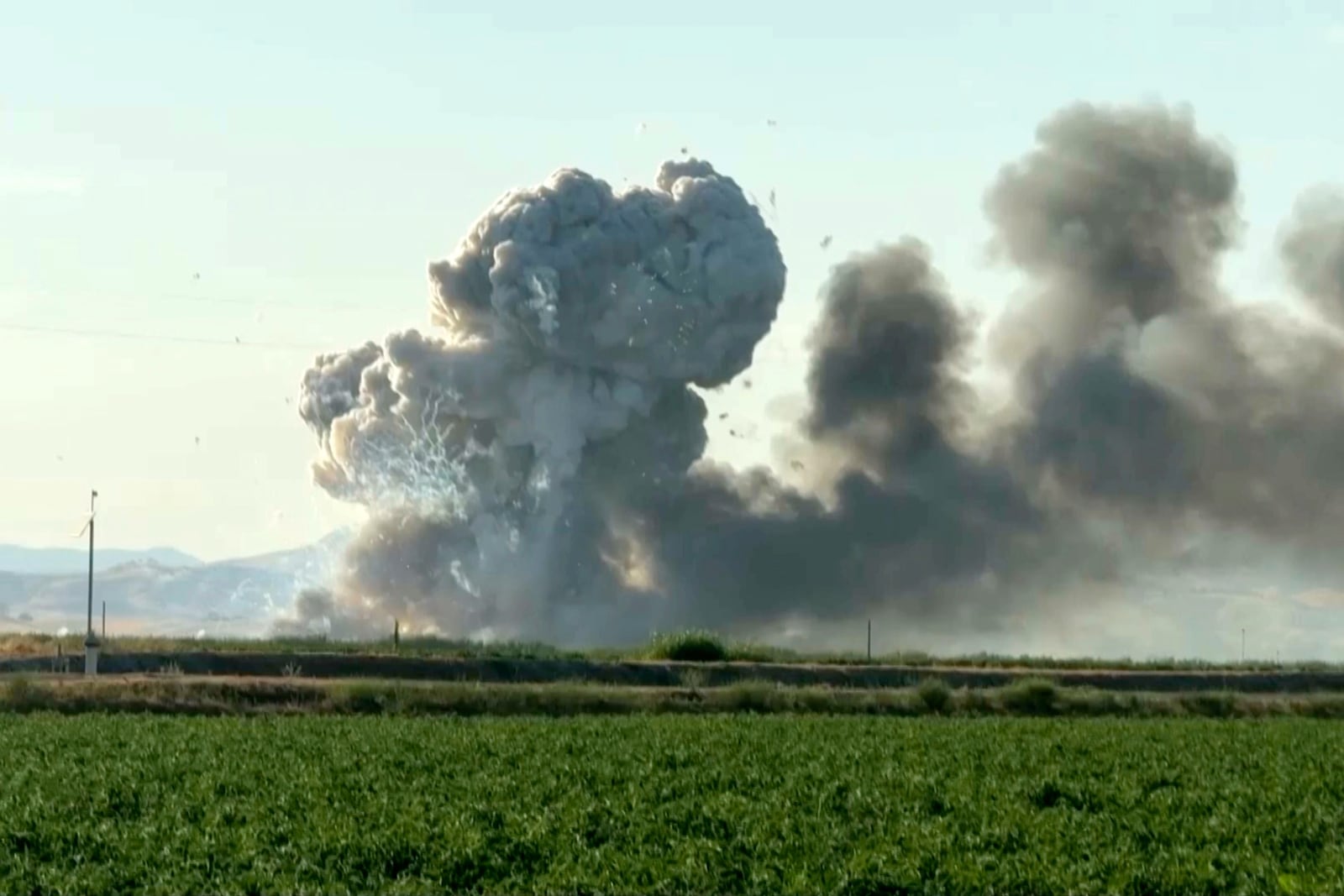 In this image taken from video, smoke and flames rise from a fireworks warehouse explosion, July 1, 2025, in Esparto, Calif. (Hudson Sheats via AP)