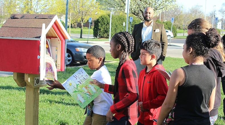 Students from Lincoln Elementary School in Springfield put books in one of the Houses of Knowledge dedicated Monday April 30, 2018. A total of seven Houses of Knowledge were installed at schools in the district. JEFF GUERINI/STAFF