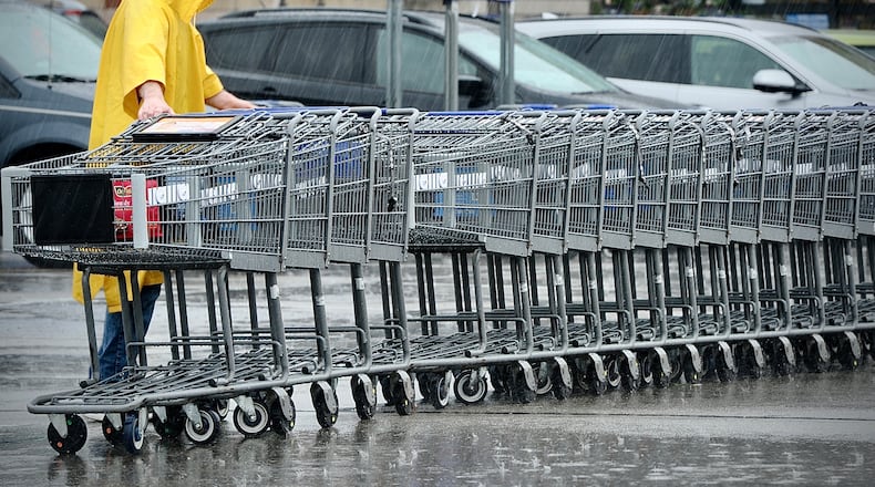 Neither rain nor snow or sleet will stop the return of shopping carts to the Kroger Market Place in Beavercreek, Wednesday, April 5, 2023. MARSHALL GORBY \STAFF