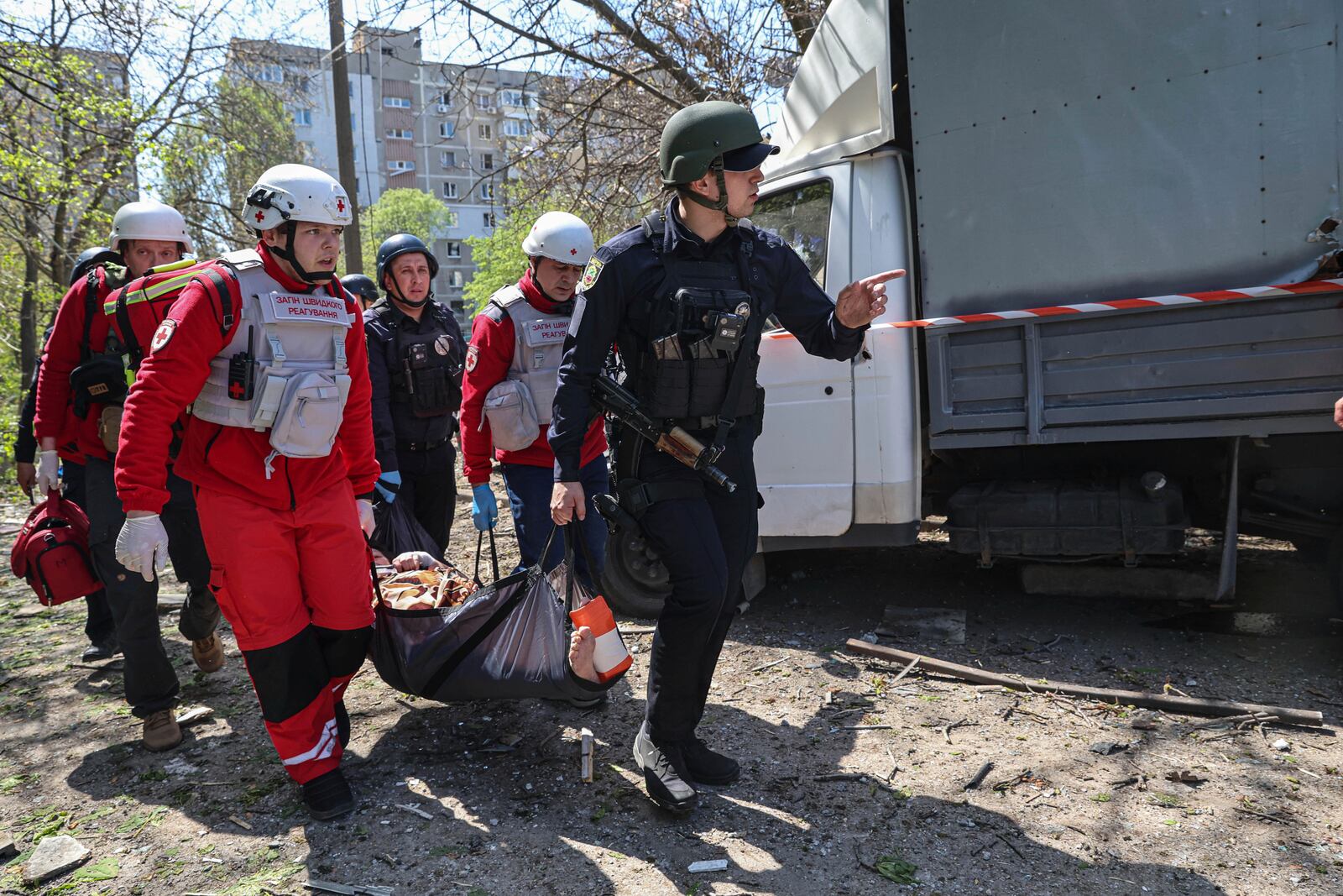 Paramedics carry an injured woman to an ambulance near a multi-storey building damaged by a Russian strike on residential neighbourhood in Zaporizhzhia, Ukraine, on Tuesday, April 22, 2025. (AP Photo/Kateryna Klochko)