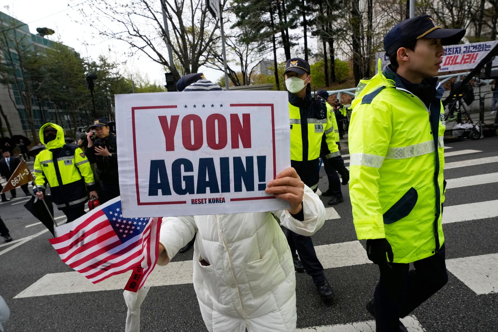 A support of South Korea's ousted President Yoon Suk Yeol walks to call for the cancellation of his removal in front of the Seoul Central District Court in Seoul, South Korea, Monday, April 14, 2025. (AP Photo/Ahn Young-joon)