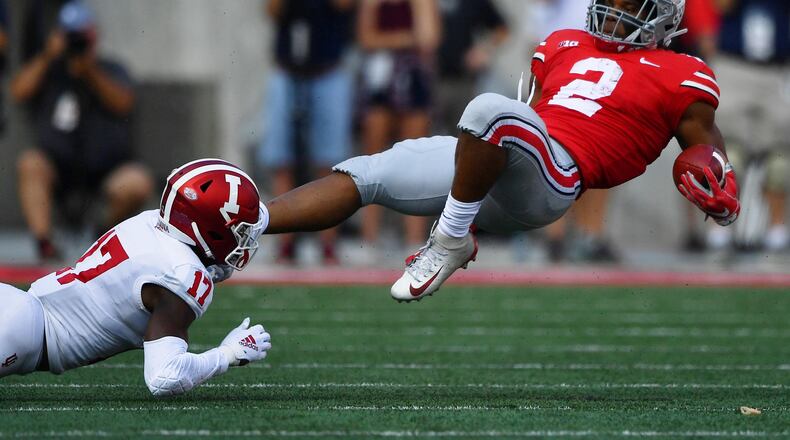 COLUMBUS, OH - OCTOBER 6: J.K. Dobbins #2 of the Ohio State Buckeyes is upended after a long gain in the first quarter by Raheem Layne #17 of the Indiana Hoosiers at Ohio Stadium on October 6, 2018 in Columbus, Ohio. (Photo by Jamie Sabau/Getty Images)