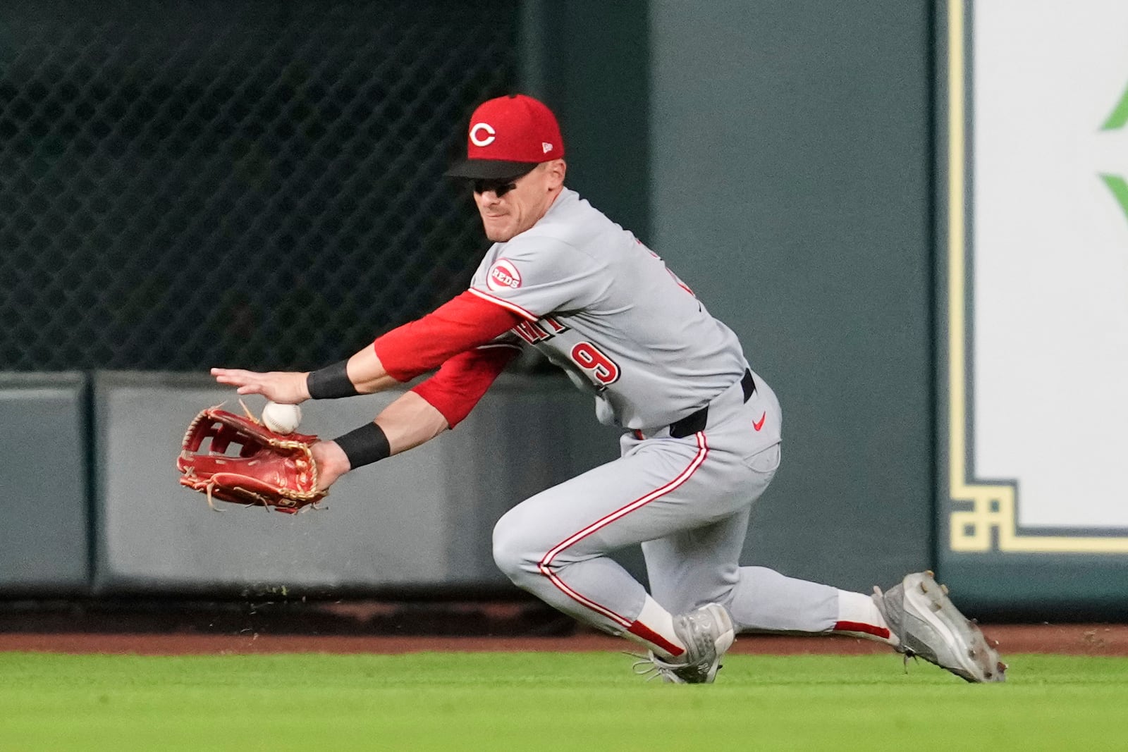 Cincinnati Reds' TJ Friedl fields a fly ball hit by Houston Astros designated hitter Brendan Rodgers during the fifth inning of a baseball game in Houston, Friday, May 9, 2025. (AP Photo/Ashley Landis)