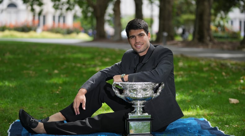 Carlos Alcaraz of Spain poses with the Norman Brookes Challenge Cup the morning after defeating Novak Djokovic of Serbia in the men's singles final at the Australian Open tennis championship, in Melbourne, Australia, Monday, Feb. 2, 2026. (AP Photo/Dita Alangkara)