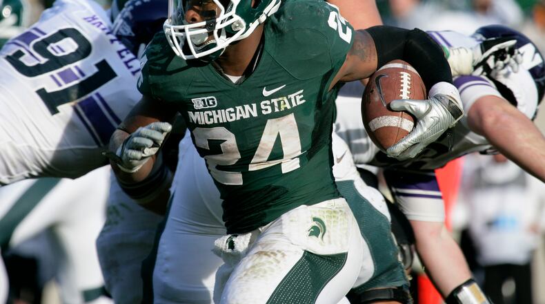 Michigan State's Le'Veon Bell (24) rushes during the fourth quarter of an NCAA college football game against Northwestern, Saturday, Nov. 17, 2012, in East Lansing, Mich. Northwestern won 23-20. (AP Photo/Al Goldis)
