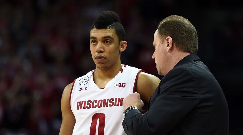 MADISON, WI - FEBRUARY 12:  Head coach Greg Gard of the Wisconsin Badgers speaks with D'Mitrik Trice #0 during a timeout against the Northwestern Wildcats at the Kohl Center on February 12, 2017 in Madison, Wisconsin.  Northwestern defeated Wisconsin 66-59. (Photo by Stacy Revere/Getty Images)