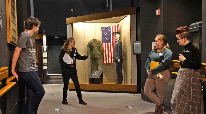 The staff at the Clark County Historical Society walks through the military gallery in the Clark County Heritage Center museum Thursday, Dec. 28, 2023 as they plan how they're going to remove some of the items from display cases so the fire suppression system can be undated while the museum is closed in January. BILL LACKEY/STAFF