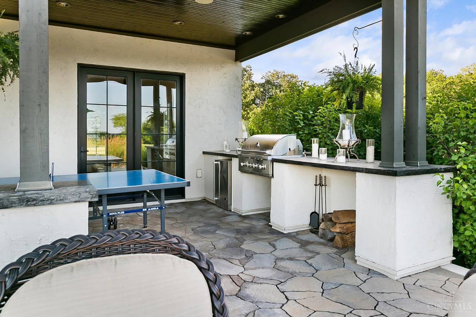 The home has stamped concrete patios surrounding most of it. This outdoor kitchen is covered and has a wood ceiling and ceiling fan. CONTRIBUTED