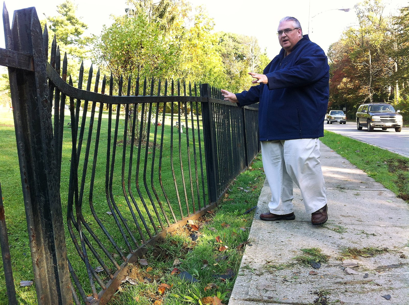In this 2013 file photo, Ferncliff Cemetery superintendent Stan Spitler talks about damage to the cemetery’s wrought-iron fence after a driver on North Plum Street ran into it.