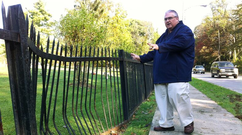 Stanley Spitler, superintendent of Ferncliff Cemetery, surveys the latest damage Friday to the cemetery’s wrought-iron fence after a driver along North Plum Street collided with it. The Ferncliff fence is a magnet for car crashes. Andrew McGinn/Staff