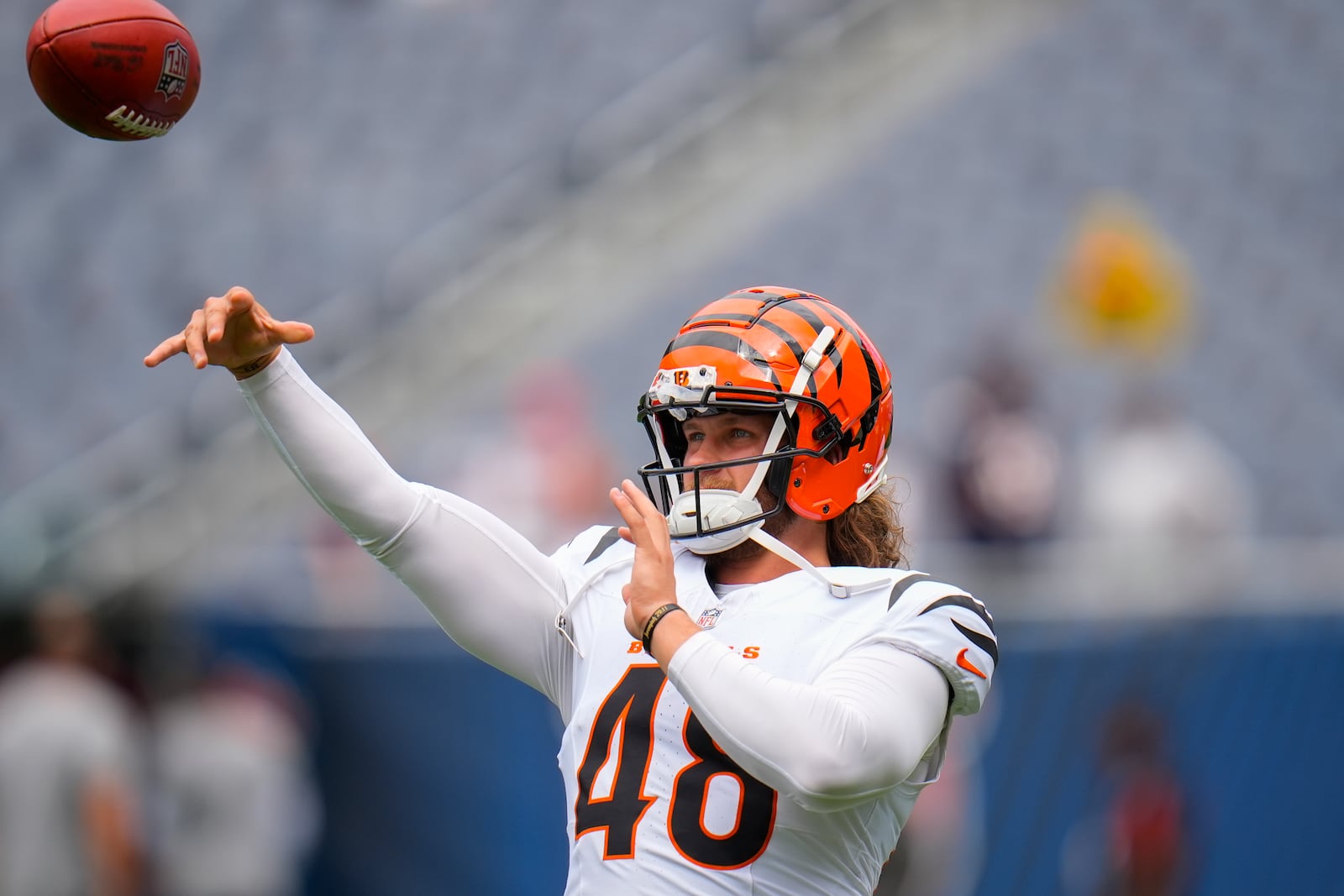 Cincinnati Bengals long snapper Cal Adomitis (48) tosses the ball on the field before the start of an NFL preseason football game against the Chicago Bears, Saturday, Aug. 17, 2024, at Soldier Field in Chicago. (AP Photo/Erin Hooley)