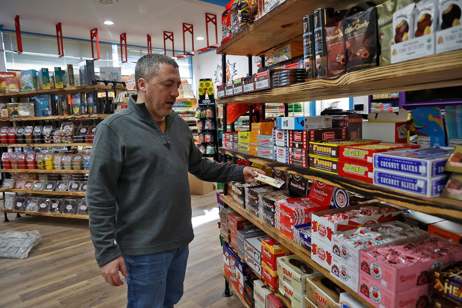 Chris Beers, owner of Grandpa Joe's Candy Shop, is shown in a November 2022 file photo talking about the old-fashioned candy the downtown Springfield shop carries. BILL LACKEY/STAFF