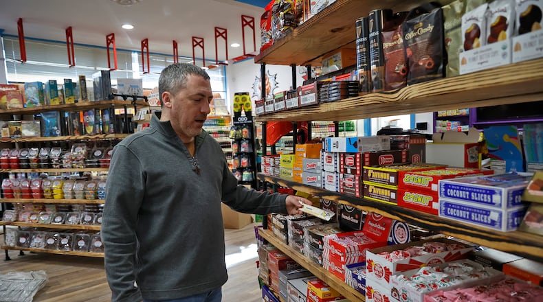 Chris Beers, owner of Grandpa Joe's Candy Shop, talks about the old fashioned candy the new Springfield candy shop will carry including pickle Monday, Nov. 14, 2022. BILL LACKEY/STAFF