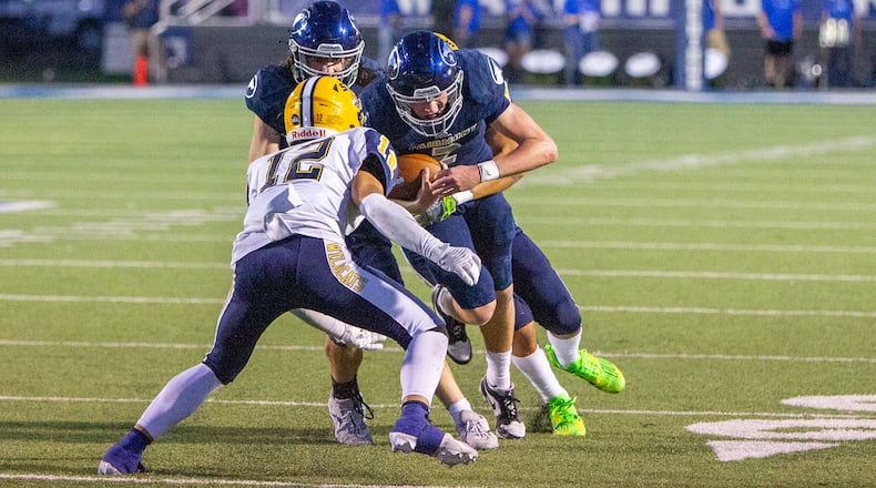 Fairmont quarterback Brock Baker takes on Springfield's Quenta Wafer Jr. during the Firebirds' first-half touchdown drive. Jeff Gilbert/CONTRIBUTED