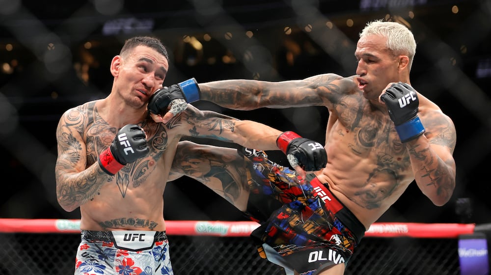 Charles Oliveira, right, punches Max Holloway in a lightweight fight during UFC 326 Saturday, March 7, 2026, in Las Vegas. (Steve Marcus/Las Vegas Sun via AP)/Las Vegas Sun via AP)