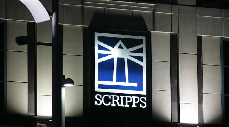 FILE - Floodlights light up the E.W. Scripps logo on the company's headquarters in Cincinnati, Jan. 31, 2006. (AP Photo/Al Behrman, File)