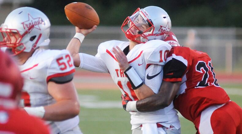 Troy QB Sam Coleman is leveled by Trotwood’s Jayvanare Nelloms. Trotwood-Madison defeated Troy 48-0 in a Week 1 high school football game on Friday, Aug. 25, 2017. MARC PENDLETON / STAFF