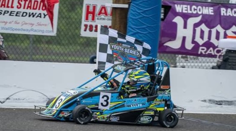 Trevor Jones holds a flag during a recent quarter-midget competition. JESSICA JONES/CONTRIBUTED PHOTO