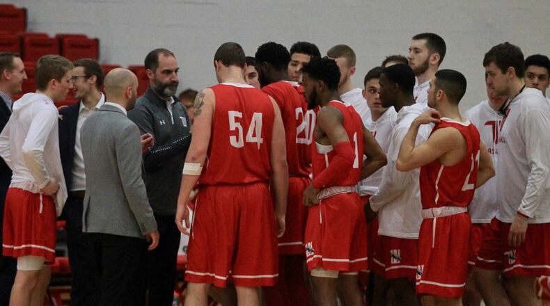 Wittenberg huddles around coach Matt Croci before a game against Denison on Wednesday, Jan. 8, 2020, at Livingston Gymnasium in Granville. David Jablonski/Staff