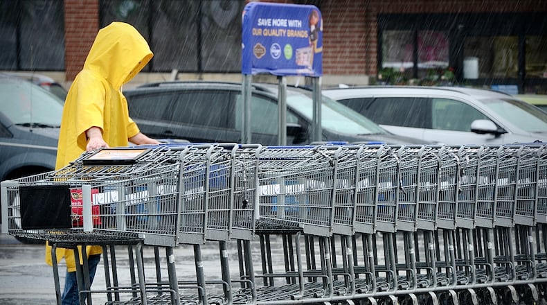 Neither rain nor snow or sleet will stop the return of shopping carts to the Kroger Market Place in Beavercreek, Wednesday, April 5, 2023. MARSHALL GORBY \STAFF