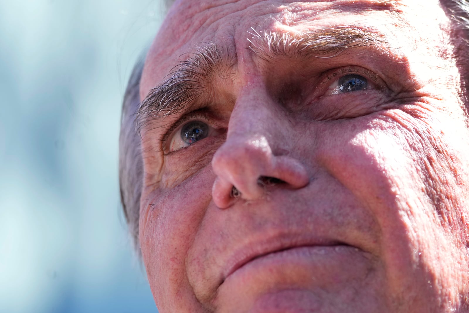 Former President Jair Bolsonaro talks to the press as he leaves the hospital after a weeks-long surgical stay, in Brasilia, Brazil, Sunday, May 4, 2025. (AP Photo/Eraldo Peres)